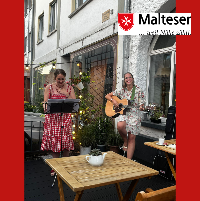 Zwei Frauen musizieren im Außenbereich eines Cafés 